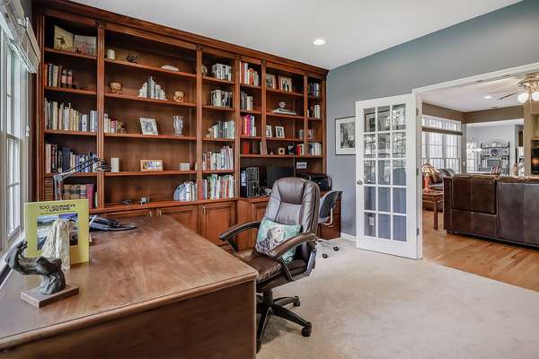 Office features French doors and built-in bookshelves!