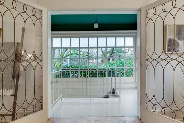 Leaded glass doors to the northeast enclosed porch and 2nd stairway to basement