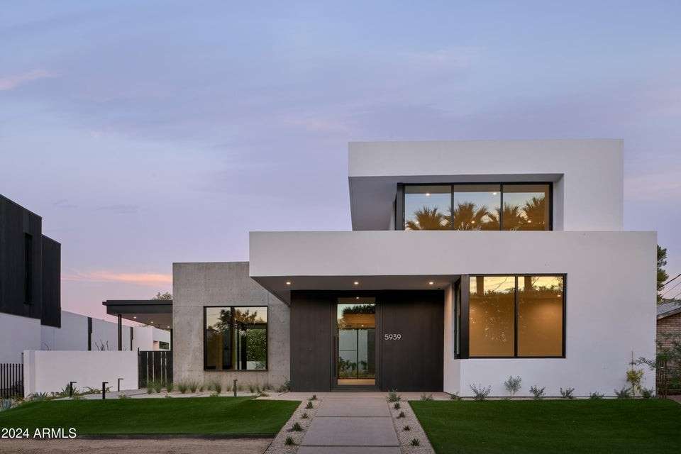 1 of 27. At golden hour, this Phoenix masterpiece stuns with its bold geometric design, expansive windows, and soft architectural lighting blending form, function, and style in the heart of Arcadia.