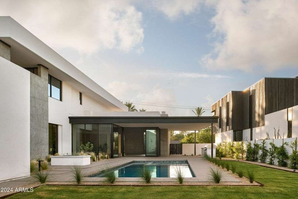 5 of 27. This sleek backyard retreat features a sparkling pool, covered patio, and clean lines that echo the home s interior elegance perfect for entertaining or peaceful Arizona mornings.